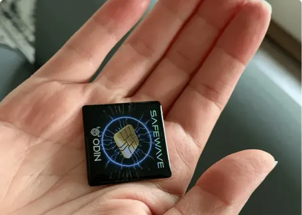 ODIN SafeWave sticker held in the palm of a hand showing its compact size