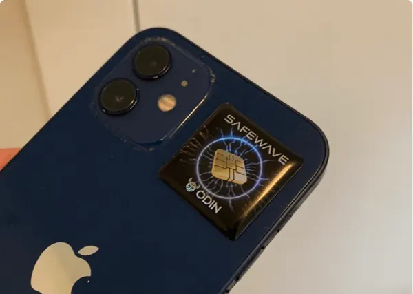 ODIN SafeWave EMF Blocking Sticker attached to the back of a blue phone
